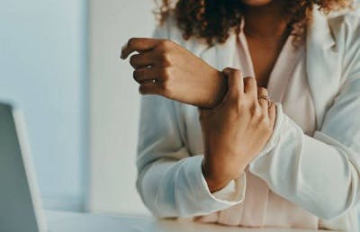 survivor with experiencing a hand tremor after head injury