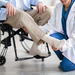 doctor examining patient's leg to determine spastic vs flaccid paralysis