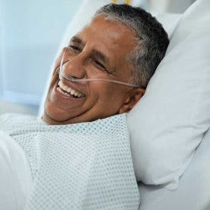 anoxic brain injury patient sitting in a hospital bed