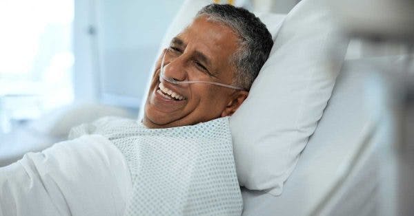 anoxic brain injury patient sitting in a hospital bed