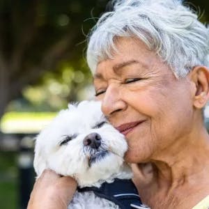 woman hearing stroke survival statistics and smiling with her dog