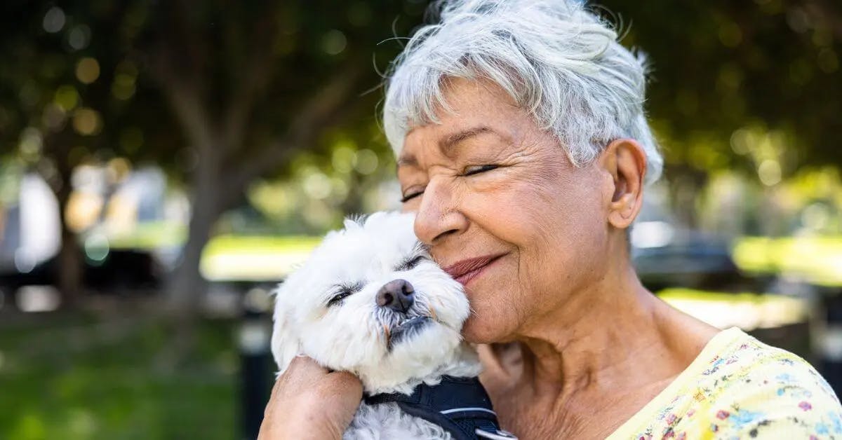 woman hearing stroke survival statistics and smiling with her dog